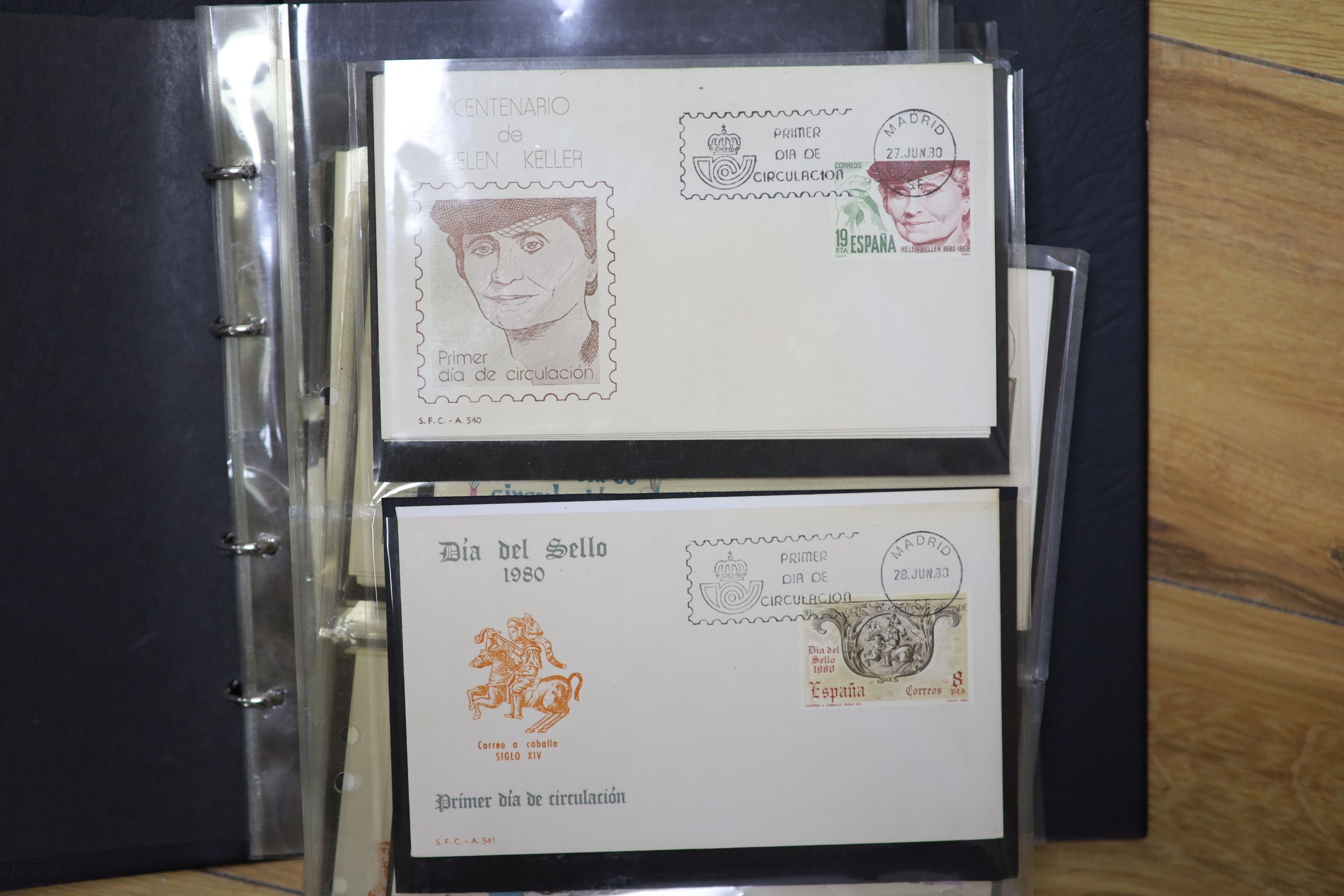 A collection of stamps and coins, including first day covers